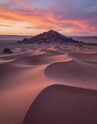 the Atacama desert at dusk transforms into a surreal alien terrain with undulating dunes of iridescent sand that shimmer in h