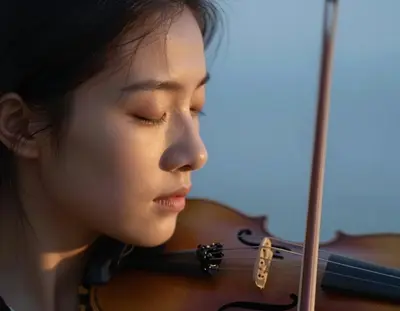 a close-up portrait of a violinist's face mid-bow-stroke, eyes closed in rapt concentration, with a dreamlike softness to the